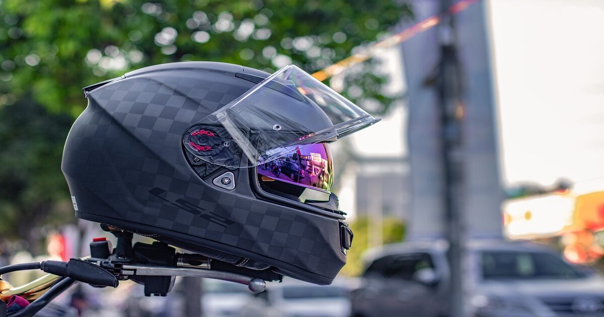 A motorcycle helmet placed on a motorcycle.